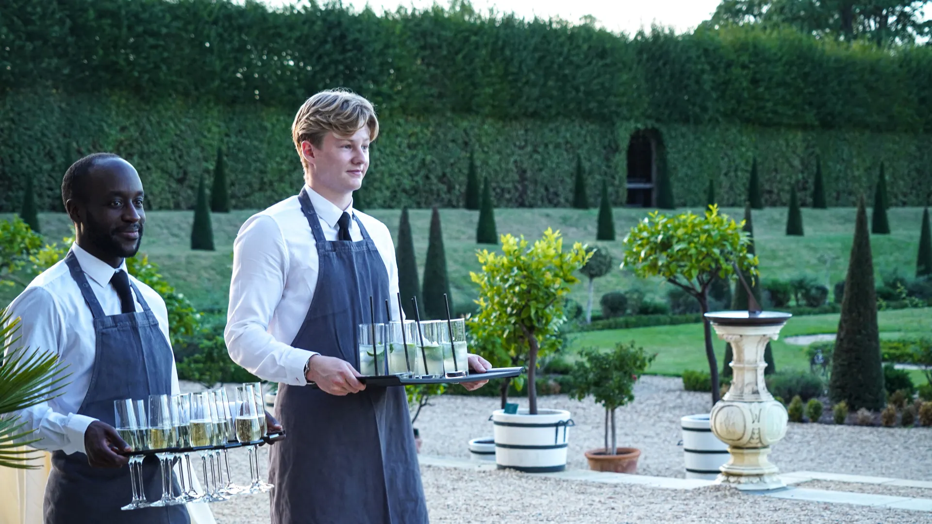 staff holding glasses at create food